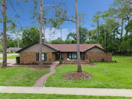 a view of a house with backyard sitting area and garden