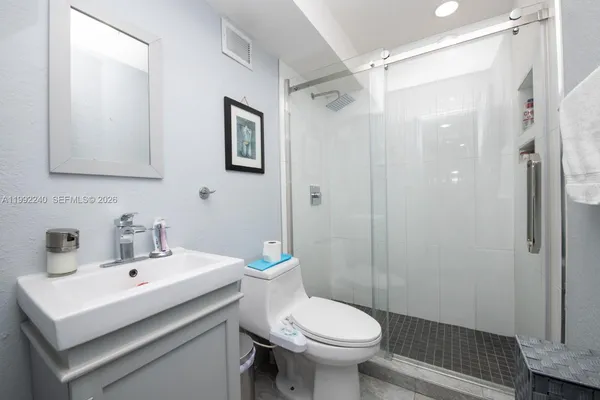 a bathroom with a sink toilet and shower