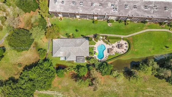 an aerial view of residential house with outdoor space and swimming pool