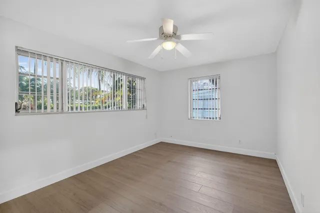 wooden floor in an empty room with a window