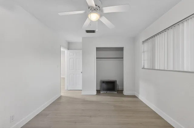a view of empty room with a fireplace and fan