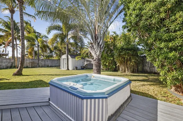 a view of a swimming pool with a patio and a yard
