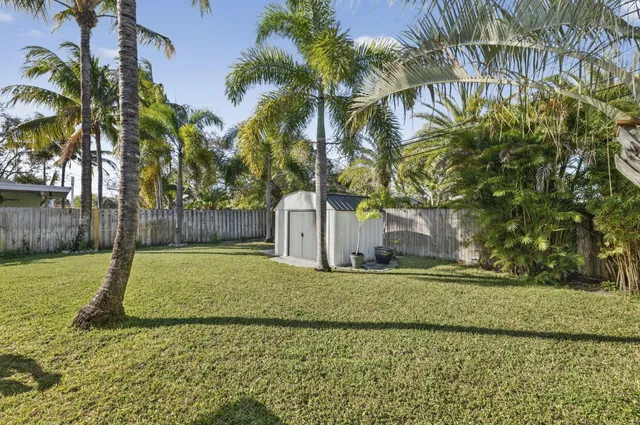 a white house with trees in front of it