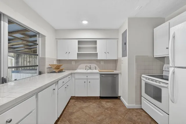 a kitchen with a sink stove and cabinets
