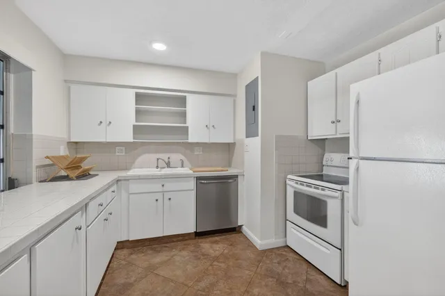 a kitchen with a sink stove and refrigerator