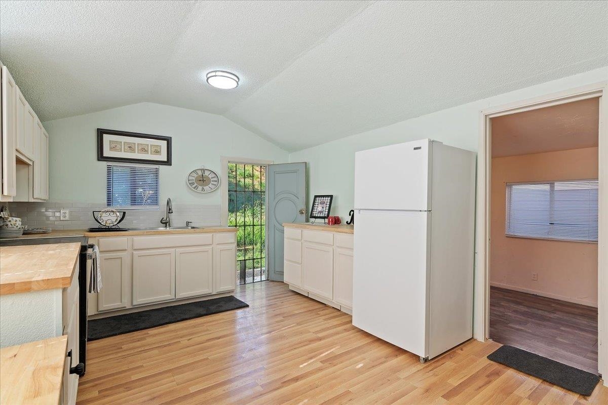 2108 Taylor Road Bethel Island, CA 94511 - Photo 13 of 31 a kitchen with white cabinets and white appliances