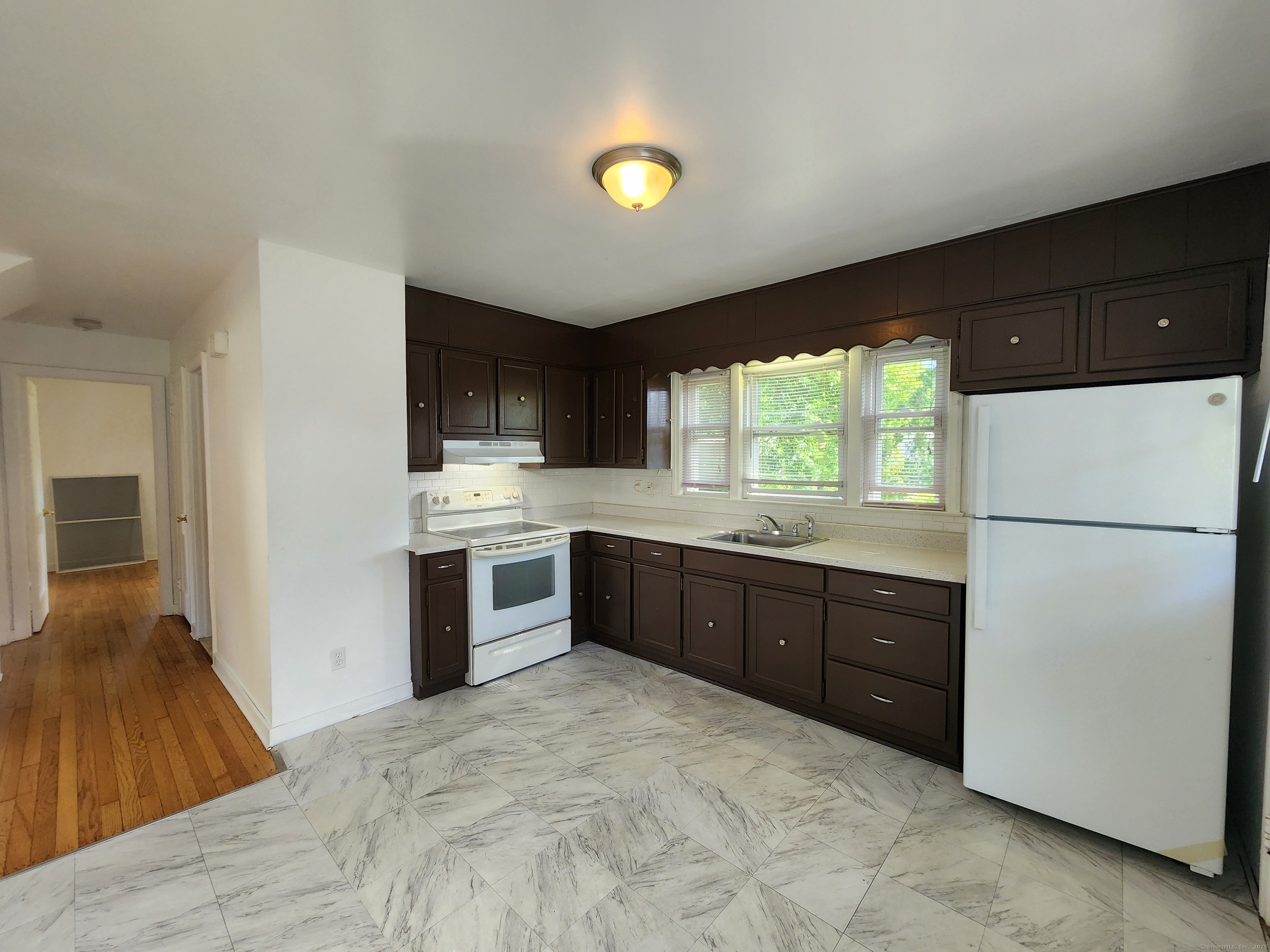 79 Honor Road West Haven, CT 06516 - Photo 11 of 36 a kitchen with a refrigerator and a stove top oven