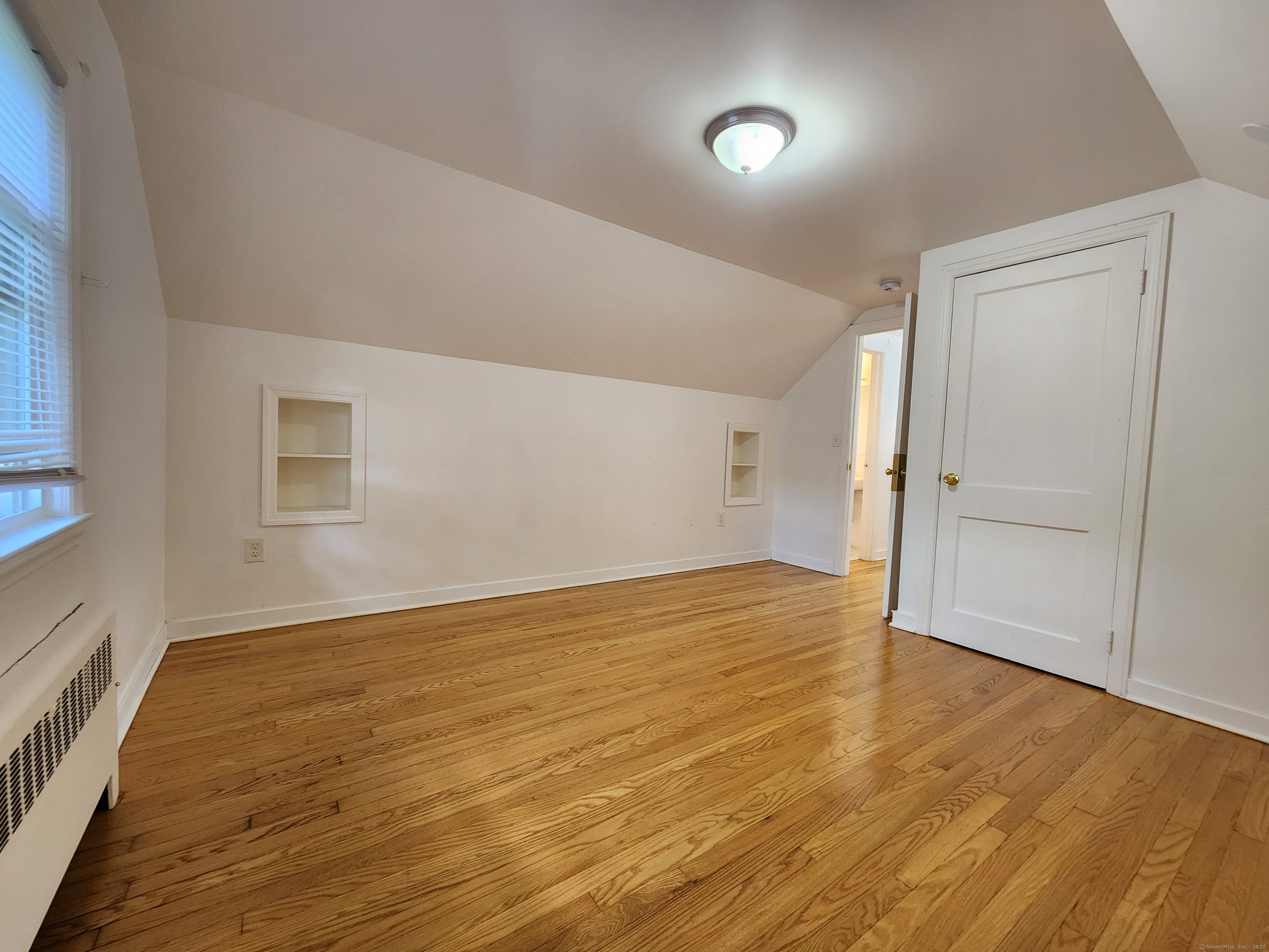 79 Honor Road West Haven, CT 06516 - Photo 16 of 36 wooden floor in an empty room with a window