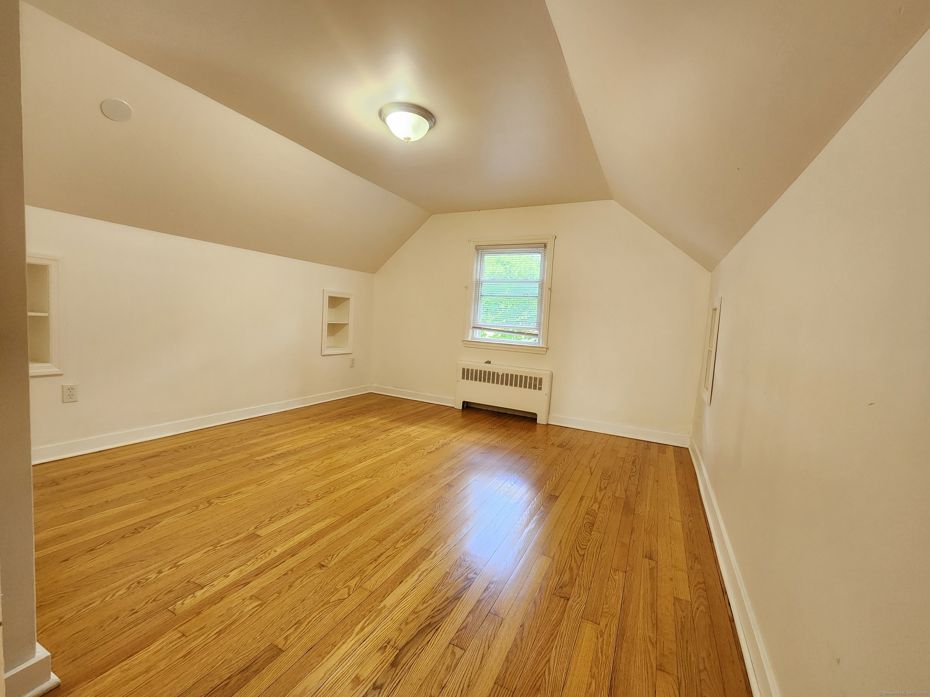 79 Honor Road West Haven, CT 06516 - Photo 23 of 36 an empty room with wooden floor and windows