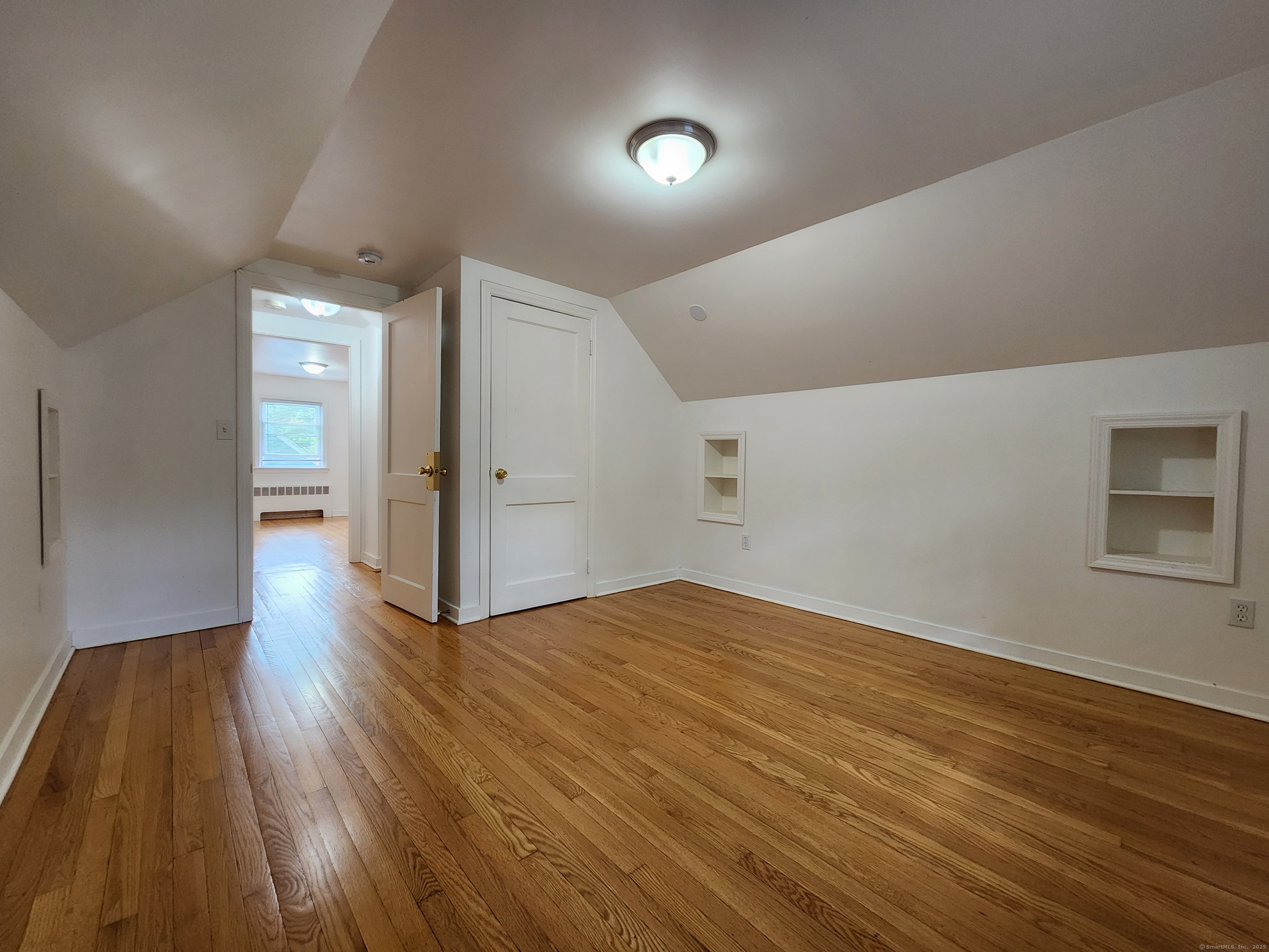 79 Honor Road West Haven, CT 06516 - Photo 24 of 36 a view of an empty room with wooden floor