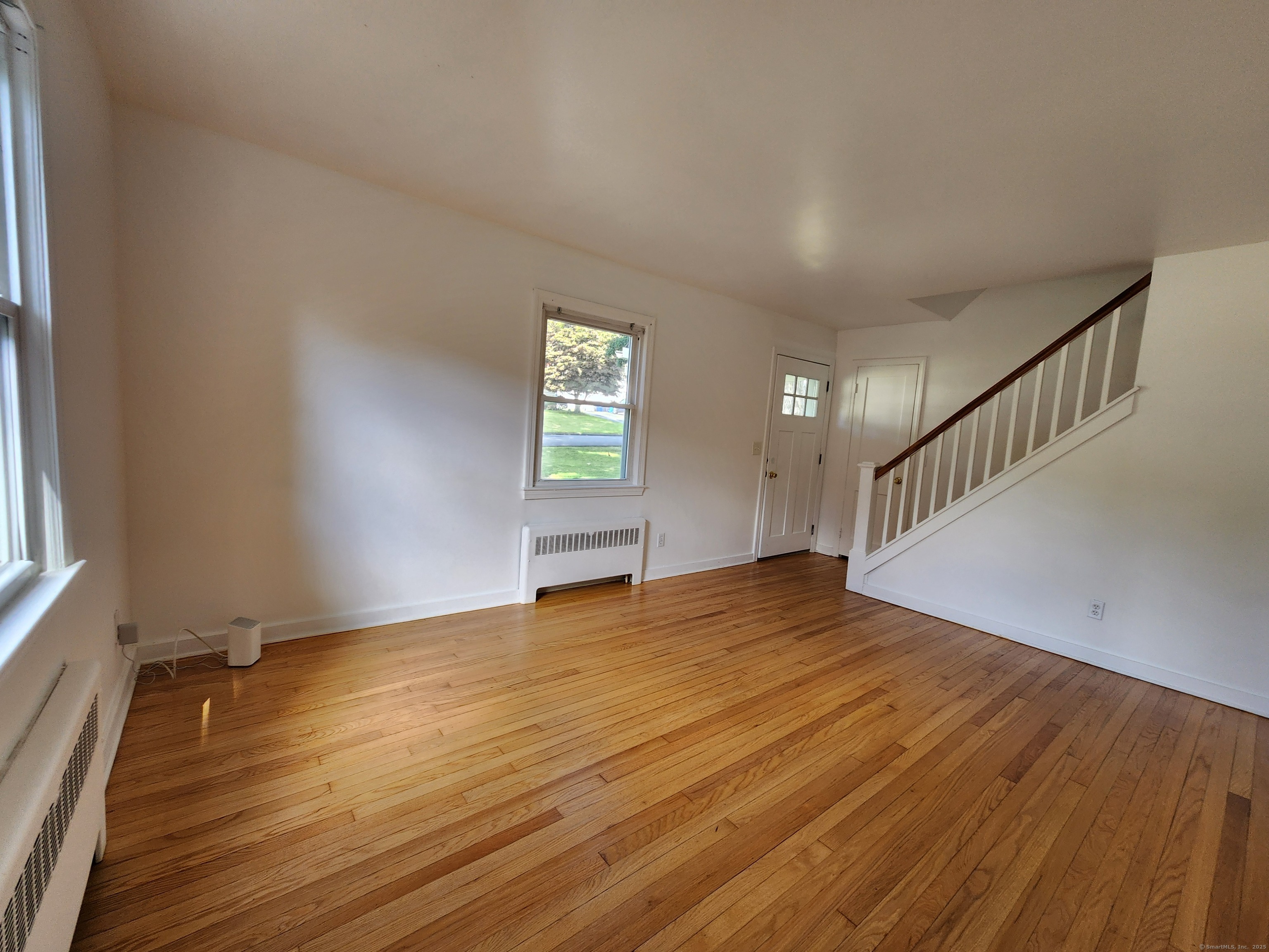 79 Honor Road West Haven, CT 06516 - Photo 8 of 36 a view of an empty room with wooden floor and a window