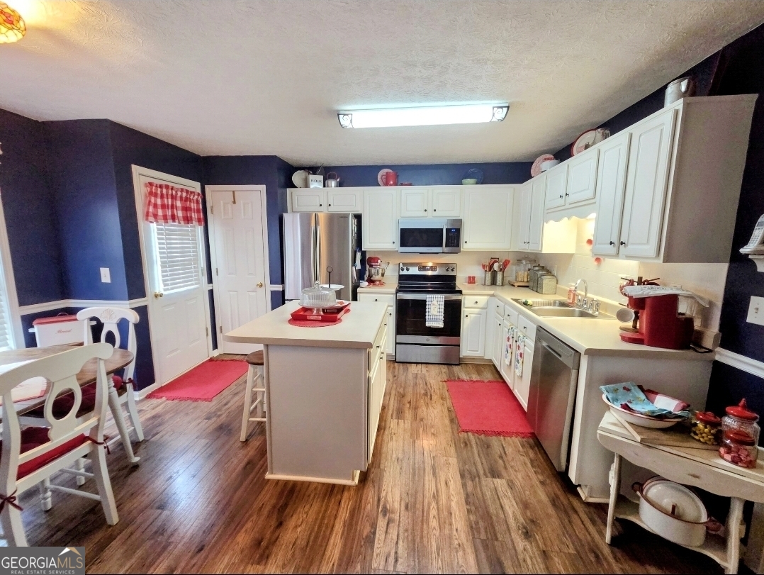21 Baskin Heights Path Temple, GA 30179 - Photo 15 of 44 a living room with kitchen appliances furniture and a flat screen tv