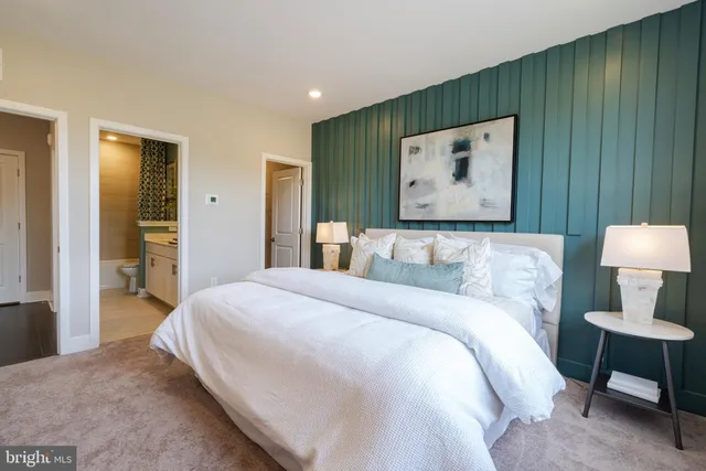 a bedroom with a bed and a painting on the wall