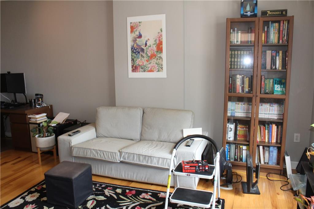 1101 Juniper Street Northeast, Unit 1416 Atlanta, GA 30309 - Photo 48 of 48 a living room with fireplace furniture and a book shelf