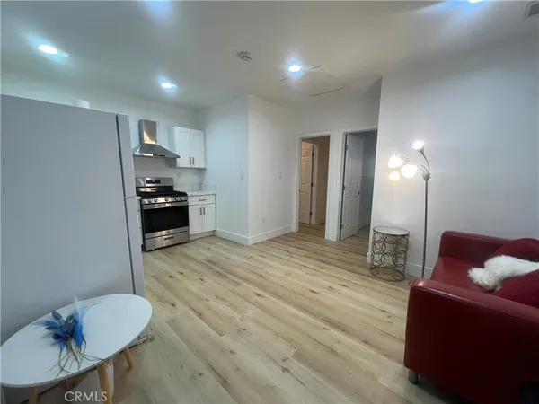 a living room with furniture a couch and wooden floor