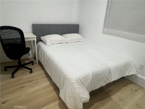 a bedroom with a bed and a desk