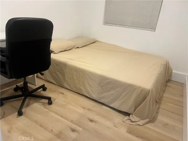 a bedroom with a bed and a chair in it