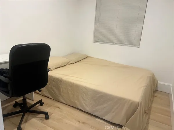 a bedroom with a bed and a chair