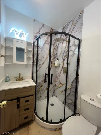 a bathroom with a sink toilet and shower