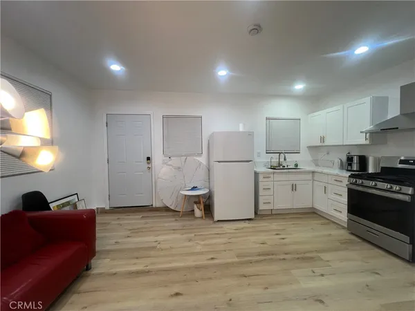 a kitchen with white cabinets and stainless steel appliances