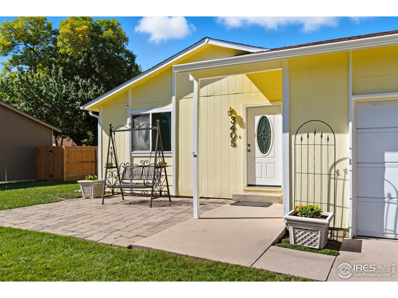 a backyard of a house with table and chairs