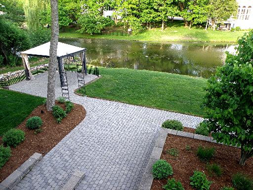 9381 Falling Waters Drive West Burr Ridge, IL 60527 - Photo 13 of 15 a view of a garden with a bench under an umbrella