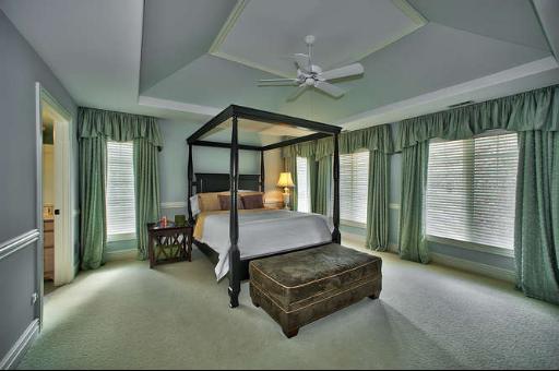 9381 Falling Waters Drive West Burr Ridge, IL 60527 - Photo 9 of 15 a bedroom with a bed and a chandelier