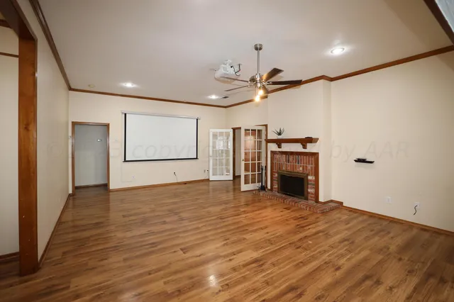 a view of a kitchen with a sink and a ceiling fan