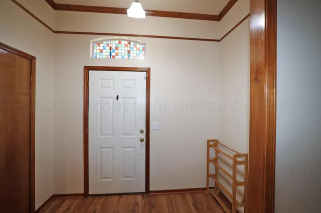 a view of an entryway with wooden floor