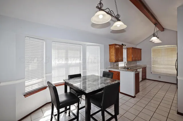 a kitchen that has a table and chairs in it