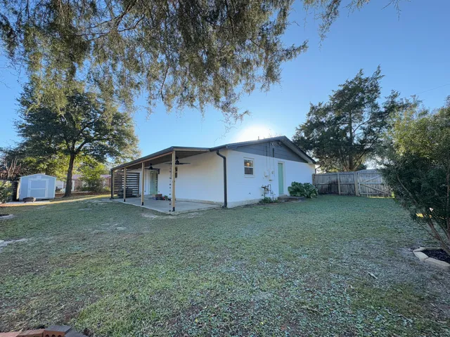 a small space with wooden floor and a window