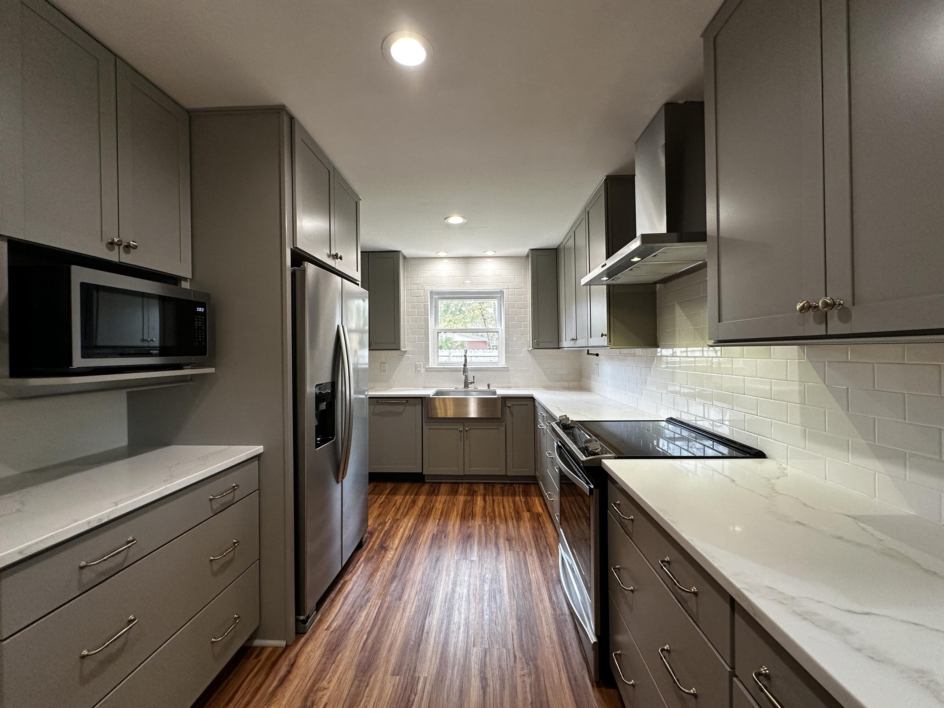 520 Justin Street Fort Walton Beach, FL 32547 - Photo 2 of 19 a kitchen with kitchen island granite countertop a sink appliances cabinets and counter space