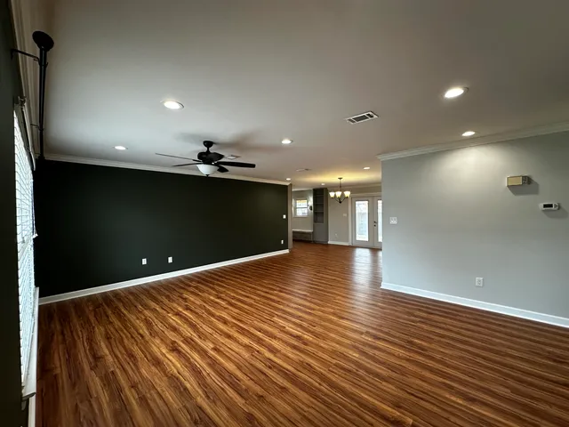 a view of a room with wooden floor