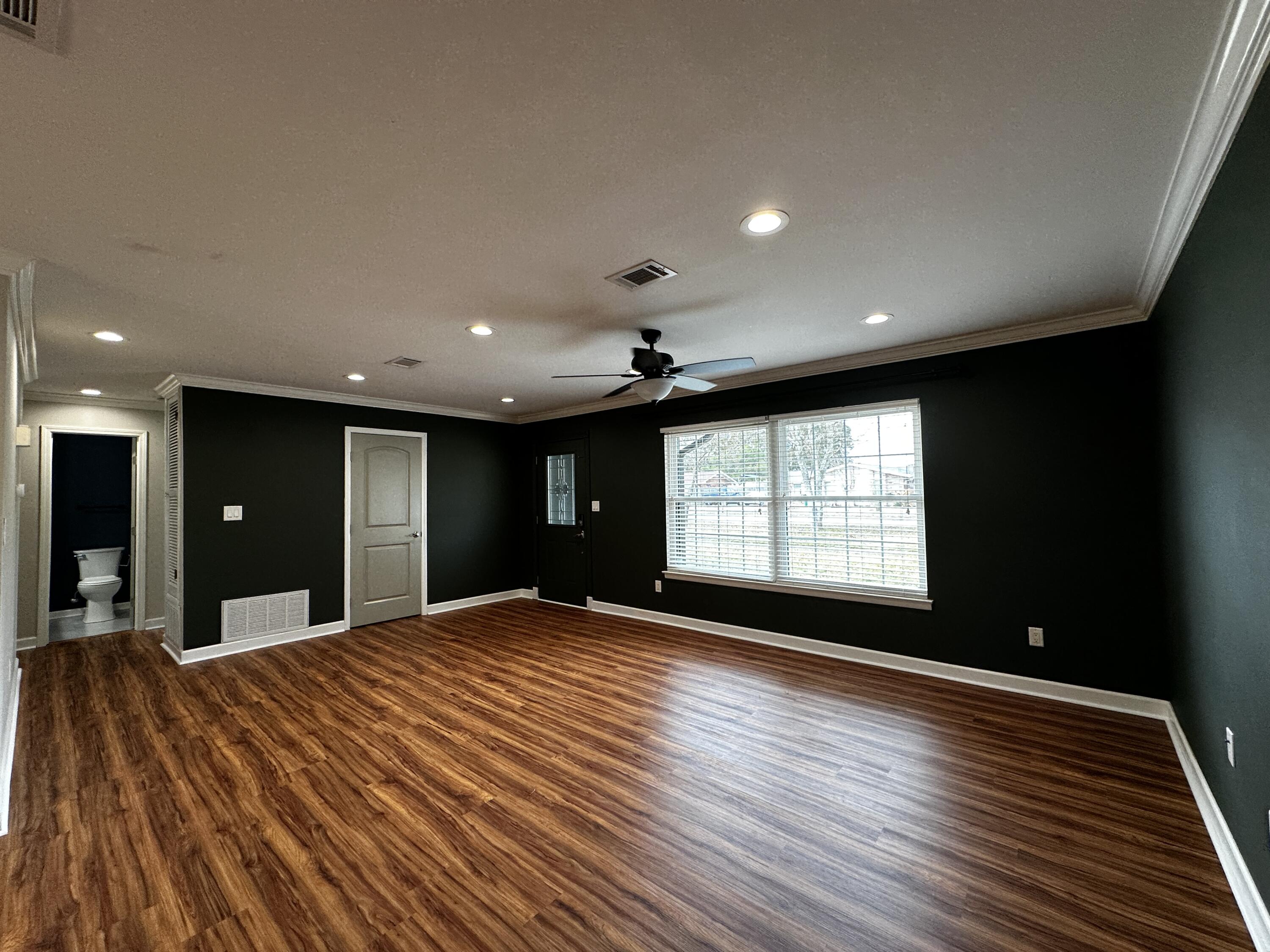 520 Justin Street Fort Walton Beach, FL 32547 - Photo 5 of 19 a view of an empty room with a window and wooden floor