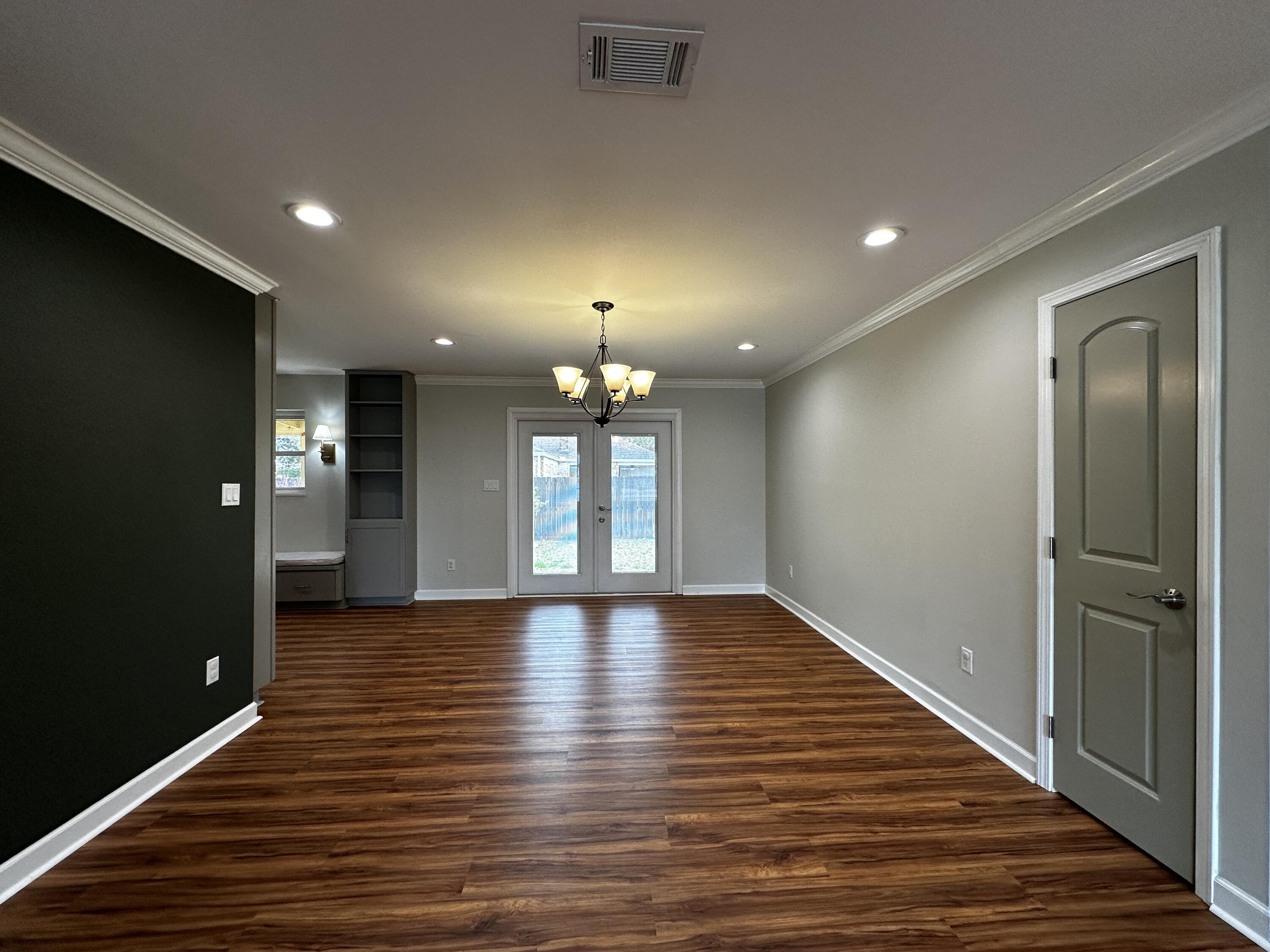520 Justin Street Fort Walton Beach, FL 32547 - Photo 19 of 19 a view of an empty room with wooden floor and a window