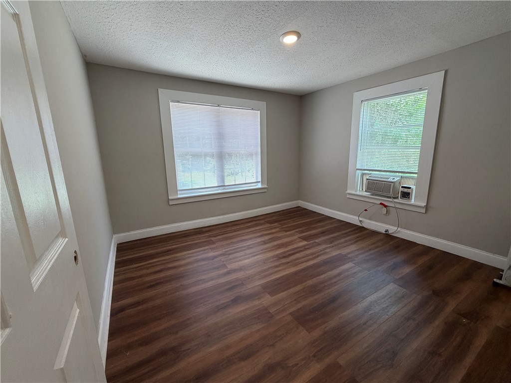 302 Sirrine Street Honea Path, SC 29654 - Photo 12 of 24 Rich hardwood-style flooring extends through this naturally illuminated bedroom, ready for your personal touch.