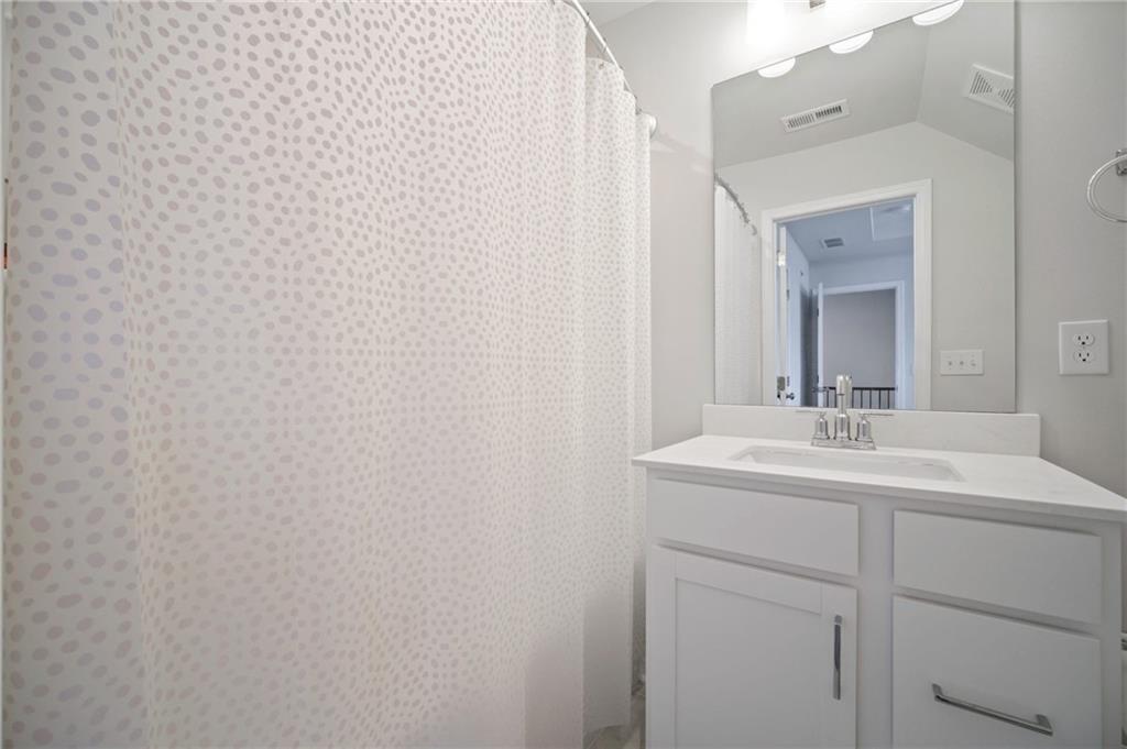 1595 Ridgebrook Downs Mableton, GA 30126 - Photo 25 of 39 a bathroom with a sink and a mirror