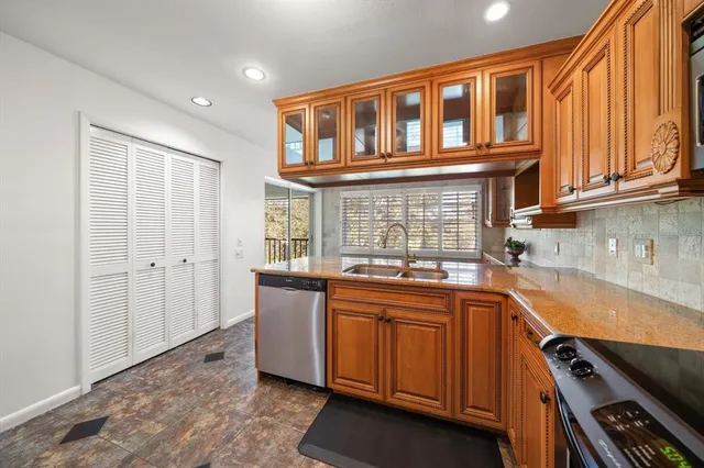 a kitchen with a sink stove and cabinets