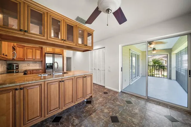 a kitchen with stainless steel appliances granite countertop a stove and cabinets