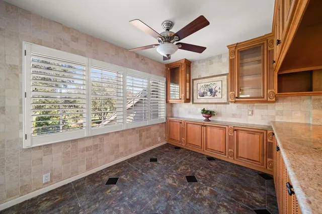 a kitchen with stainless steel appliances cabinets a large window and a sink
