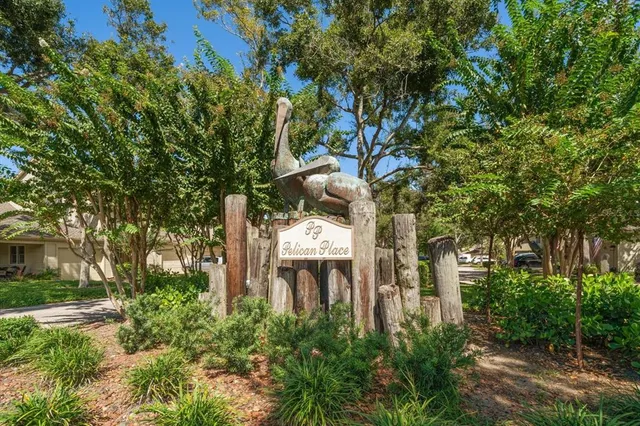 a front view of a house with a yard and fountain in middle