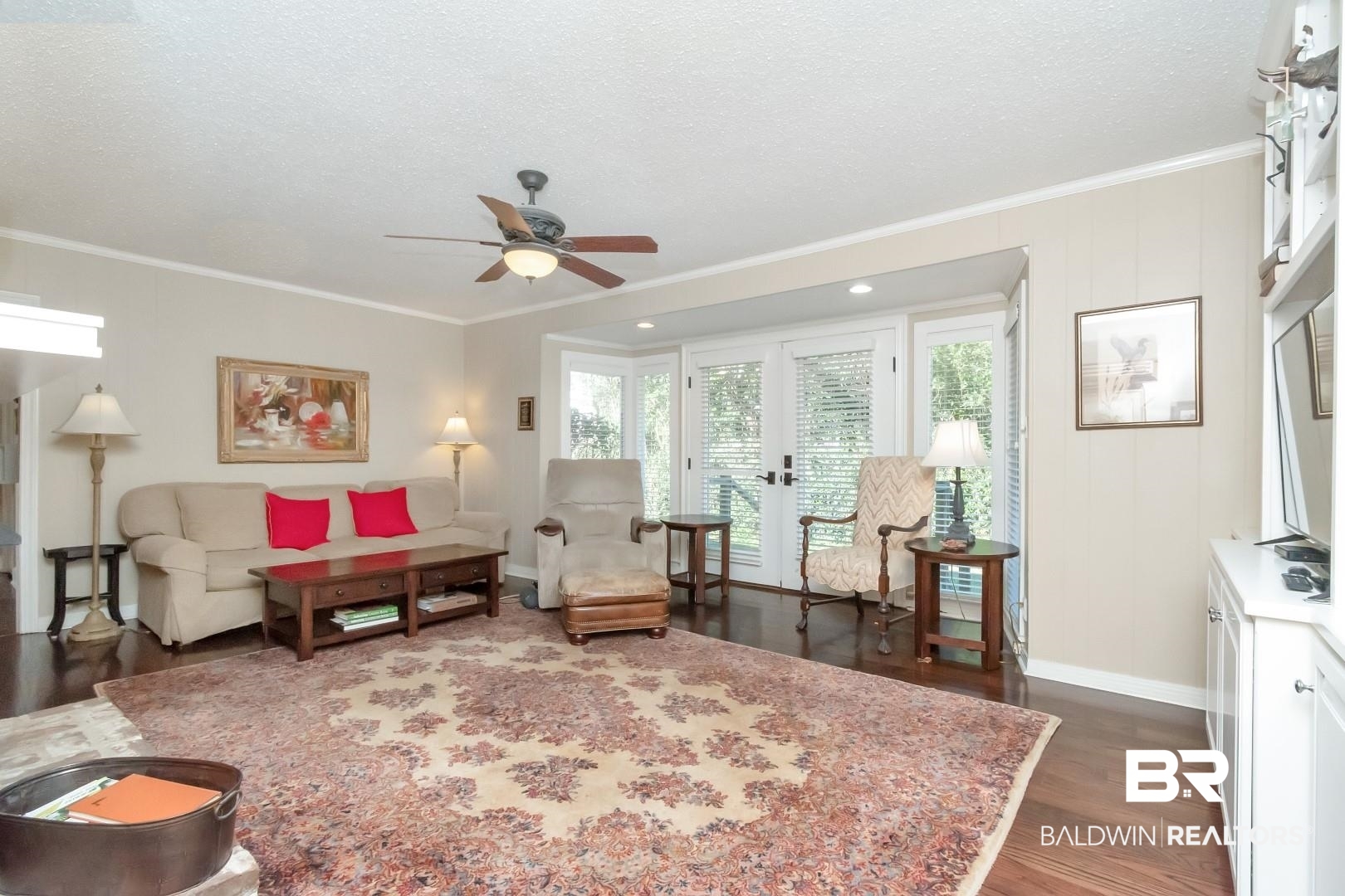 302 Springwood Drive East Mobile, AL 36608 - Photo 12 of 35 Living room with ceiling fan, french doors, dark wood-type flooring, crown molding, and a textured ceiling