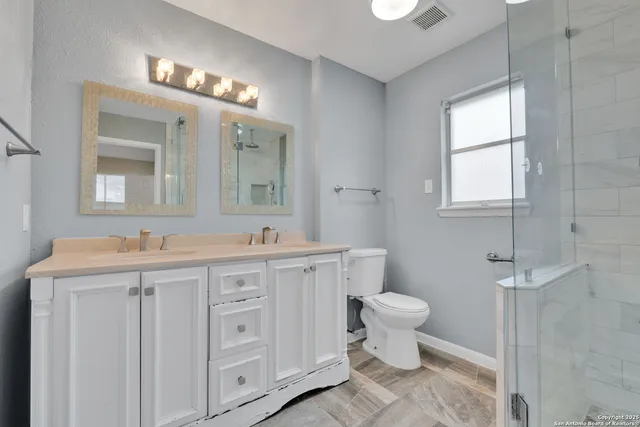 a bathroom with a toilet sink and mirror