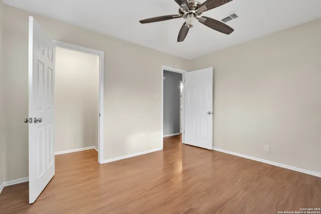 a view of an empty room and wooden floor