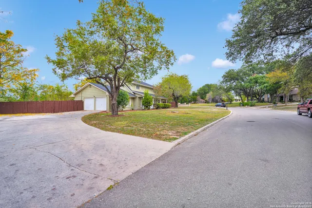 a view of a house with backyard and tree