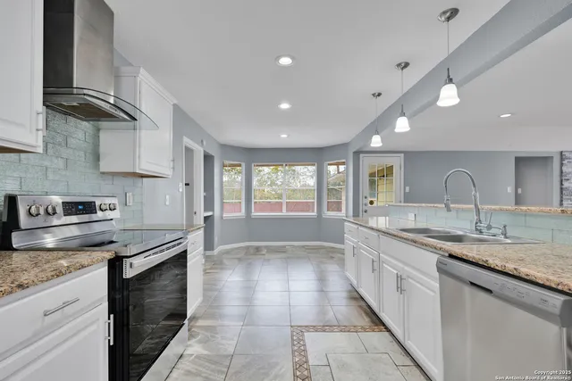 a kitchen with a sink stove and cabinets