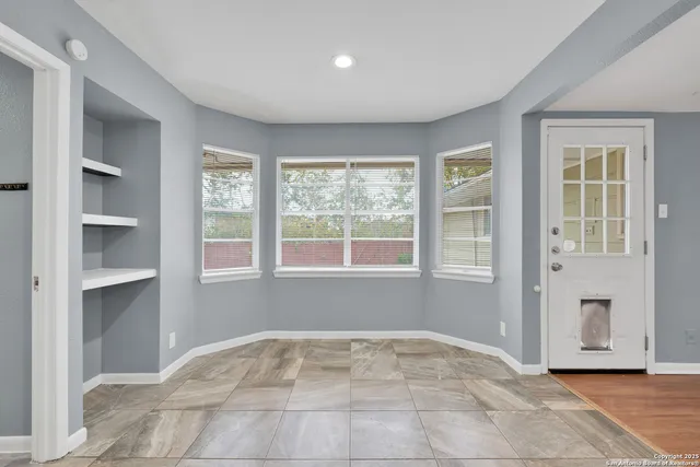 a view of an empty room with a window