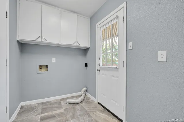 a view of a storage and utility room with a window
