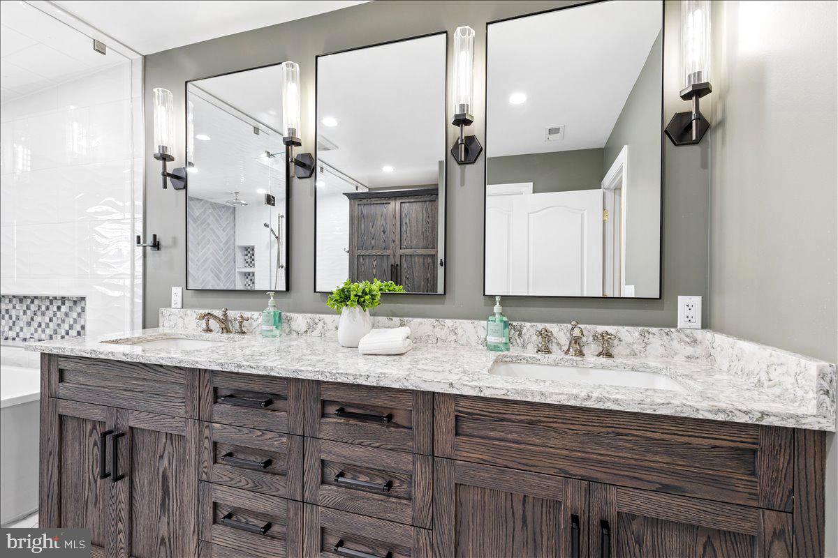 102 Little Neck Road Stevensville, MD 21666 - Photo 33 of 77 a bathroom with a granite countertop double vanity sink and a mirror