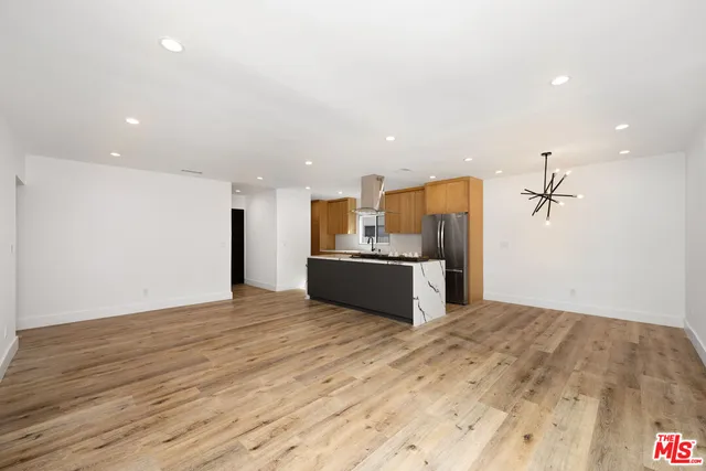a view of a kitchen with a sink and a refrigerator